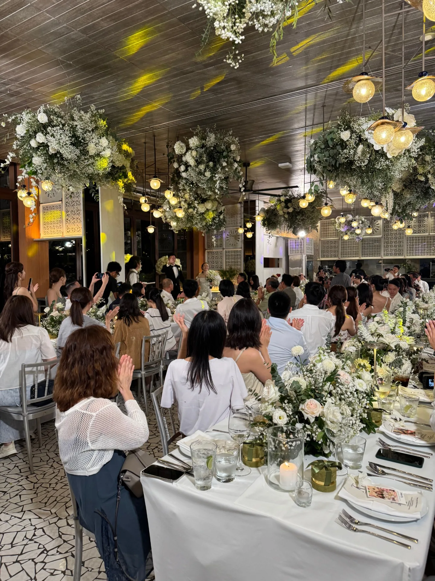 Indoor reception with hanging floral chandeliers