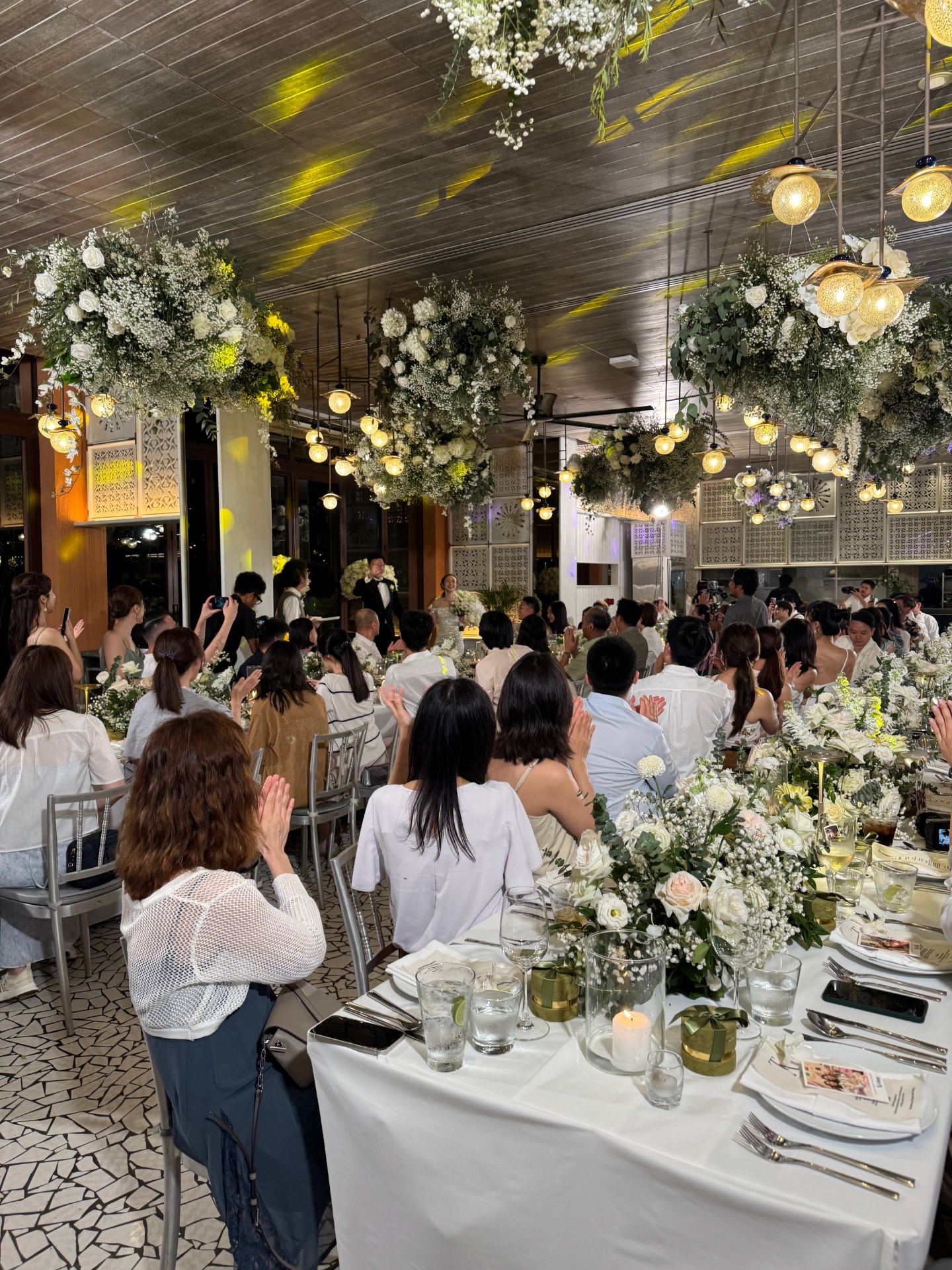 Indoor reception with hanging floral chandeliers