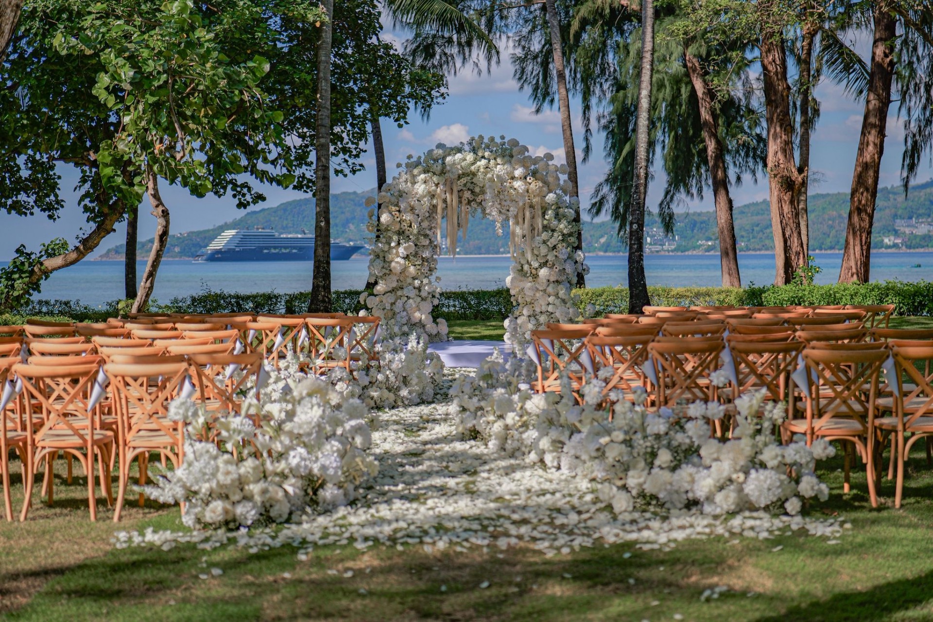 Beachfront floral arch ceremony setup