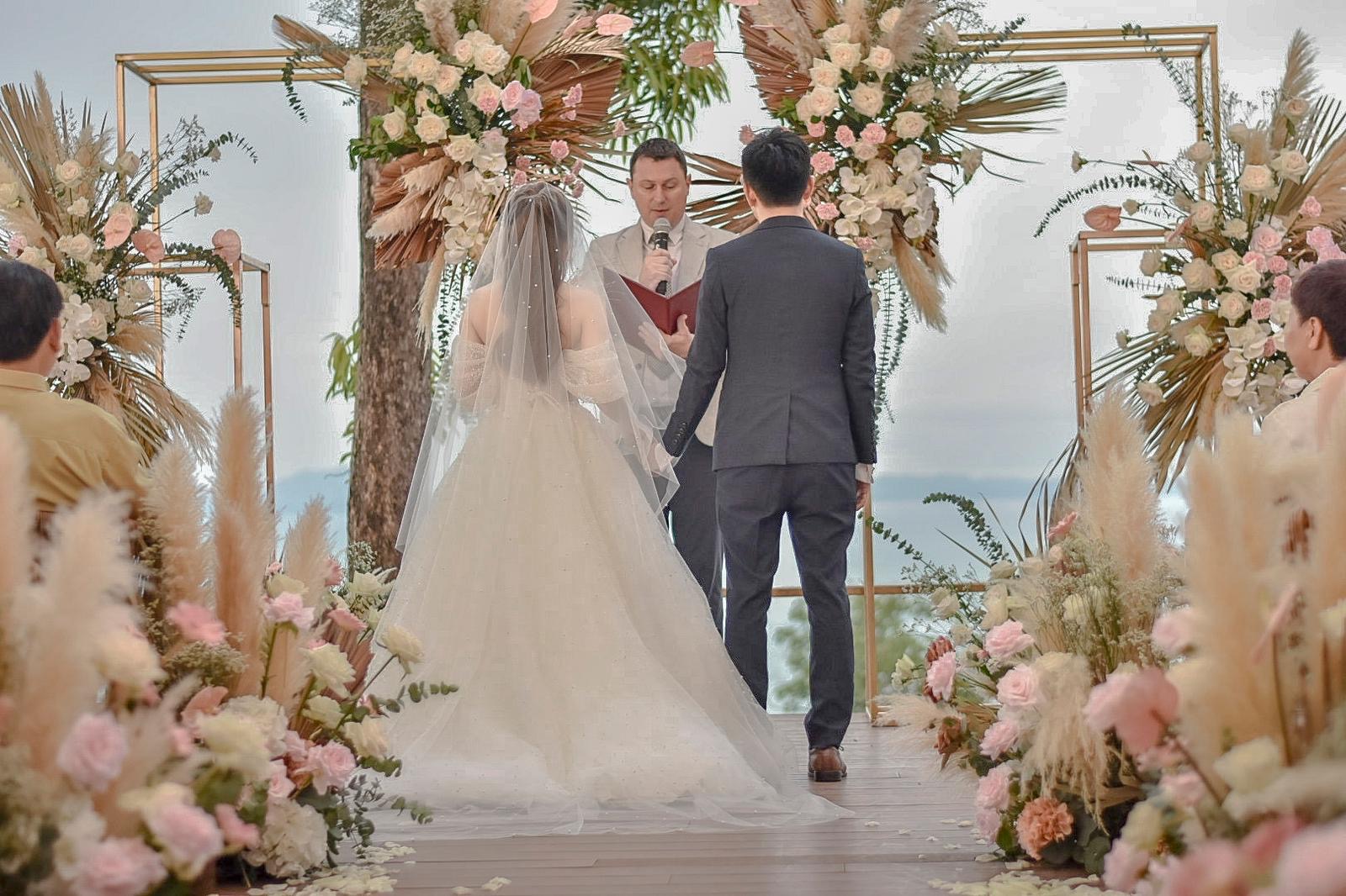 Beachside floral arch vow exchange